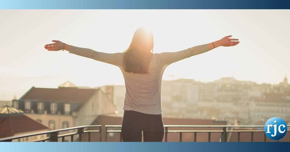 woman with arms raised