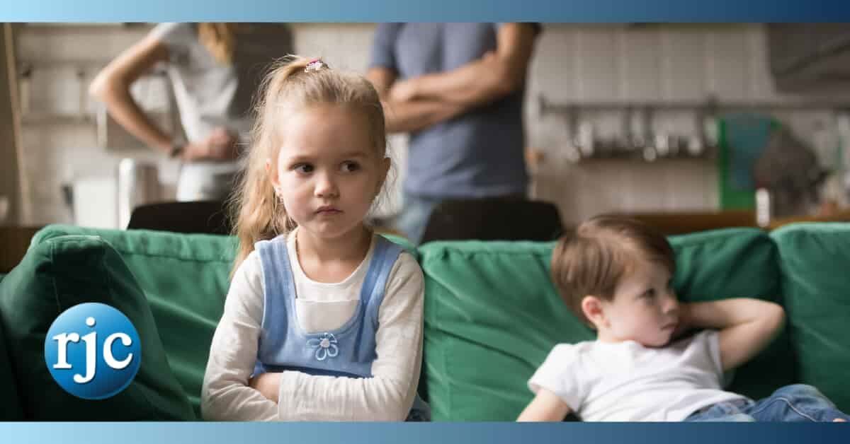 children looking upset in front of angry parents