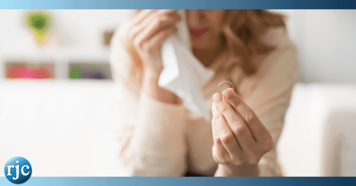 crying woman holding ring