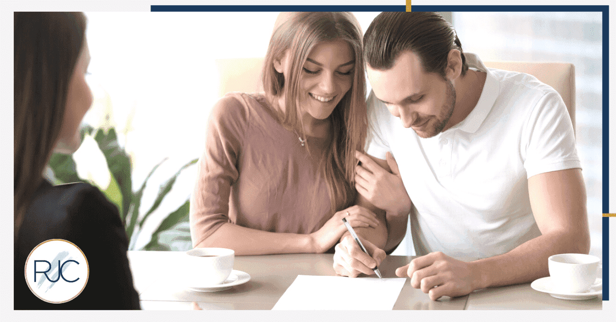 couple signing papers