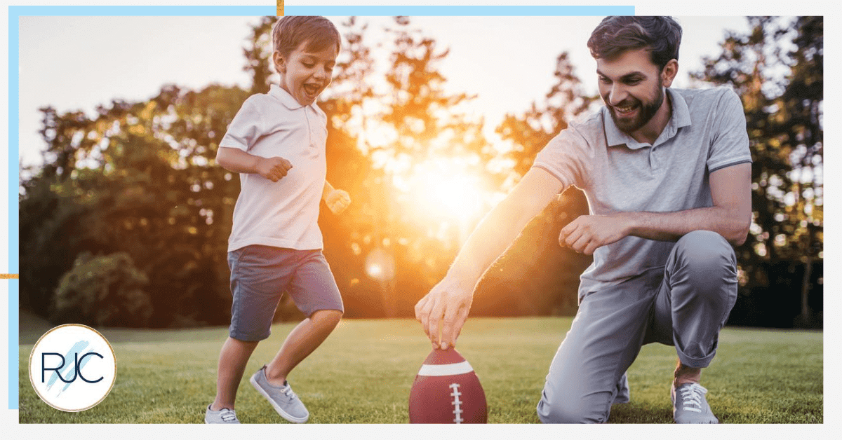 dad and son playing american football