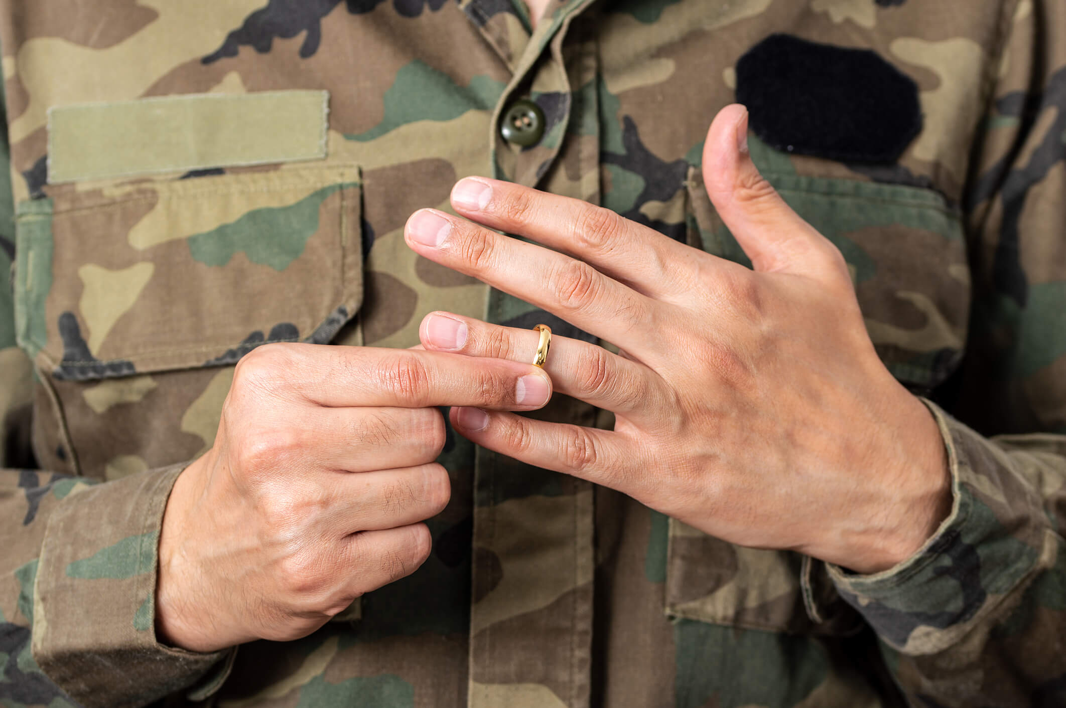 Military solider removing wedding ring